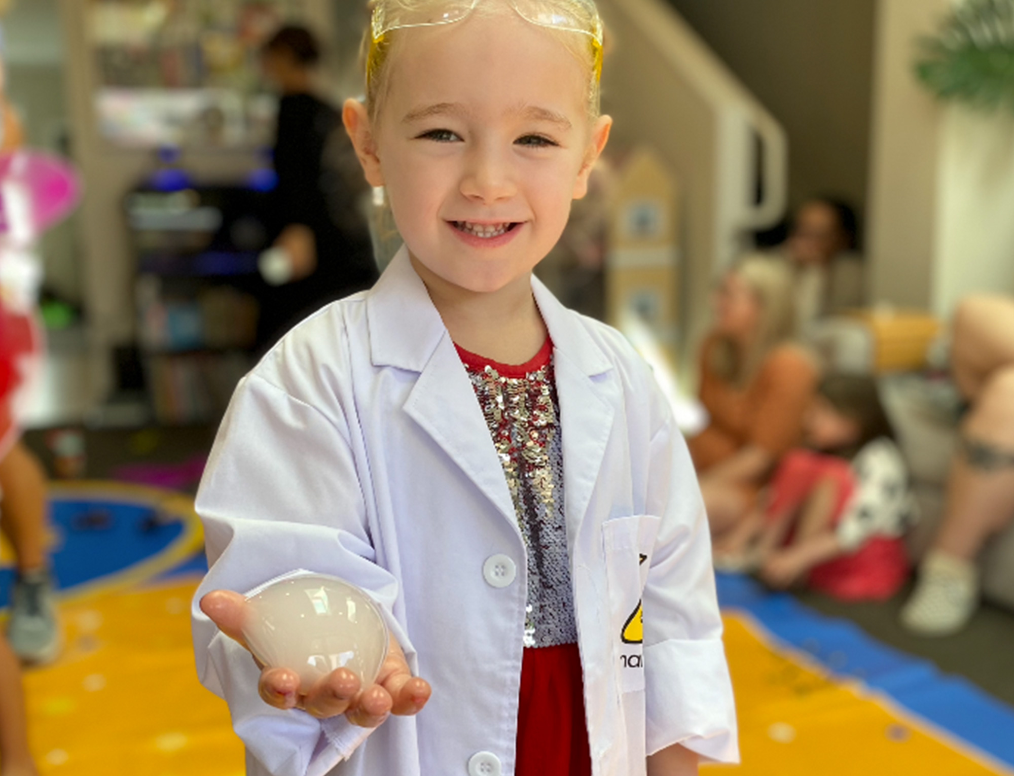 Girl holding bubble at Nanogirl science birthday party