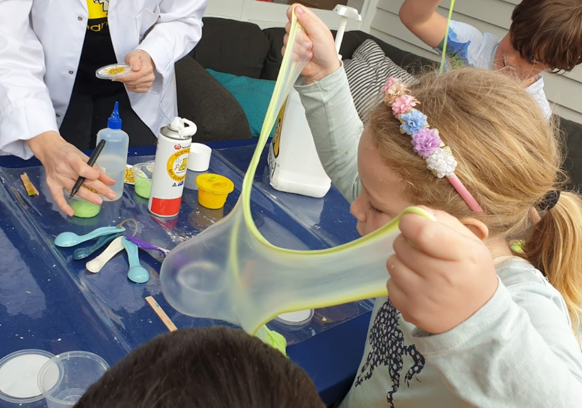 Girl plays with slime at nanogirl science party